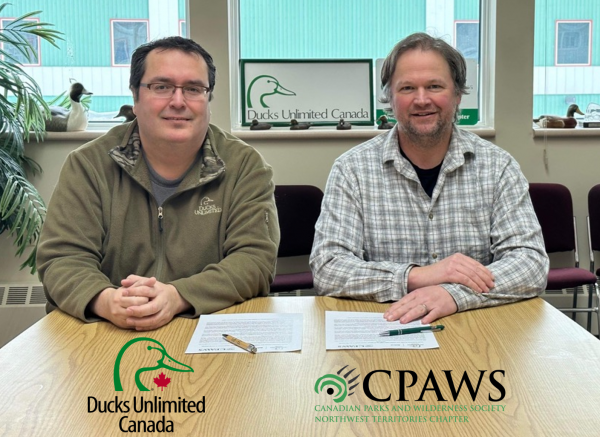 Barrett Lenoir, Conservation Programs Sepcialist of NWT and Kris Brekke, Executive Director of CPAWS-NWT sign Collaboaration Agreement